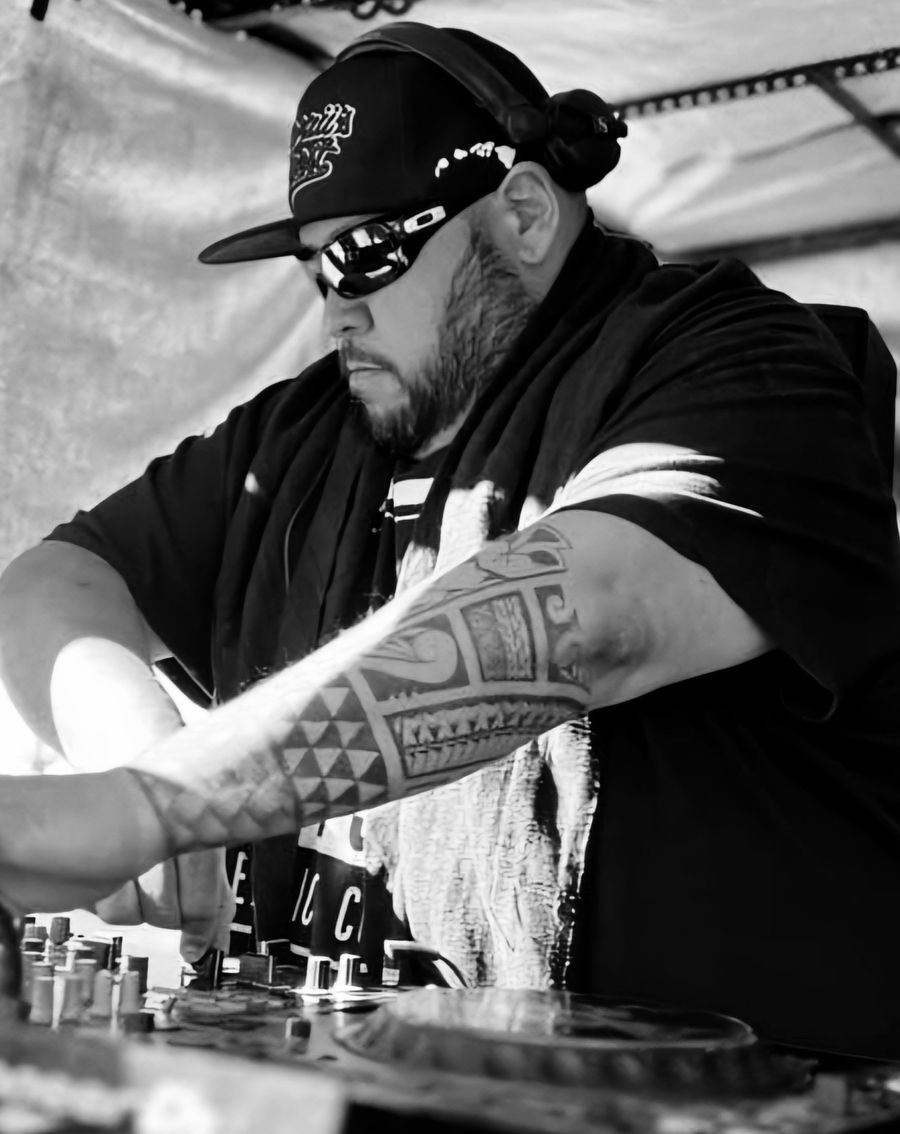 XPLCT1 mixing a drum and bass set, shot in black and white